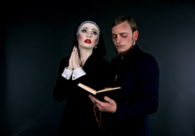 A man and woman dressed as the clergy