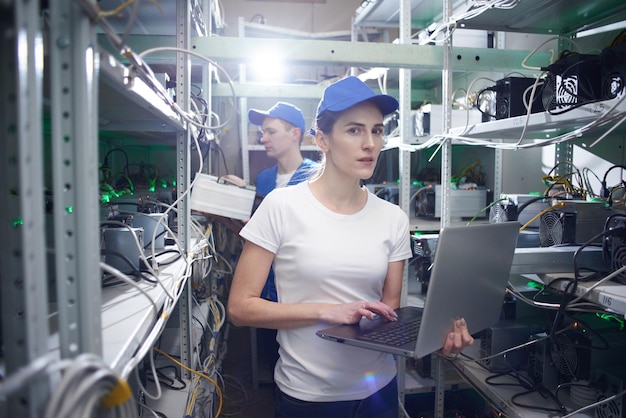 Man and woman on the farm for the extraction of crypto currencies. Bitcoin mining