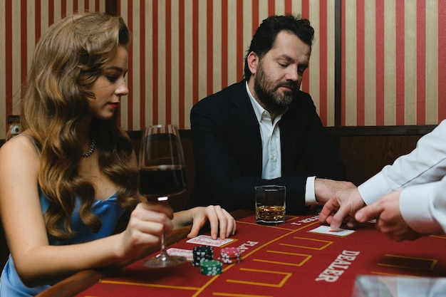 Photo man and woman gambling in casino stock photo