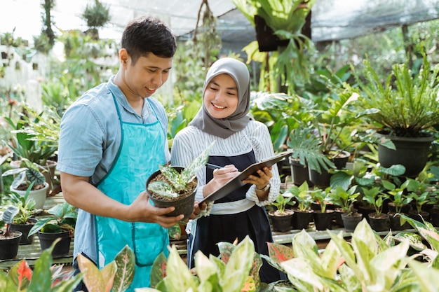 男と女の庭師が植物をチェック