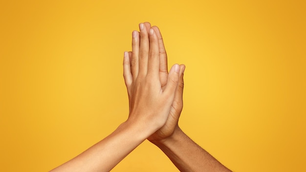 Man and woman greeting each other with high five