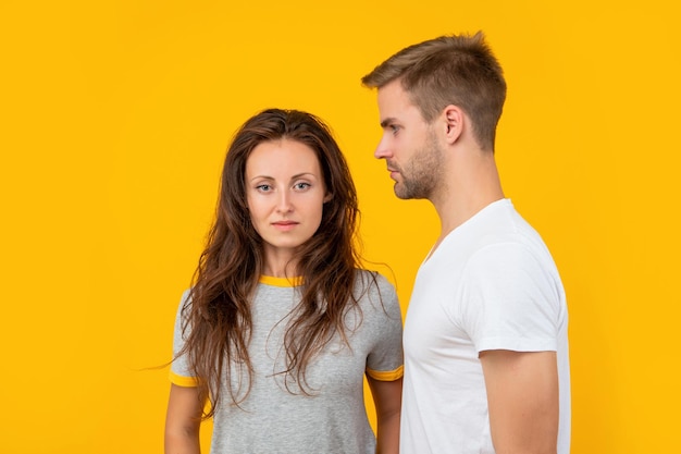 Man and woman. guy and girl together. togetherness. concept of romantic relationship. fashion and beauty. stylish sexy couple on yellow background. young students.