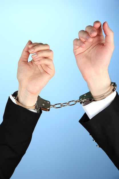 Man and woman hands and breaking handcuffs on color background