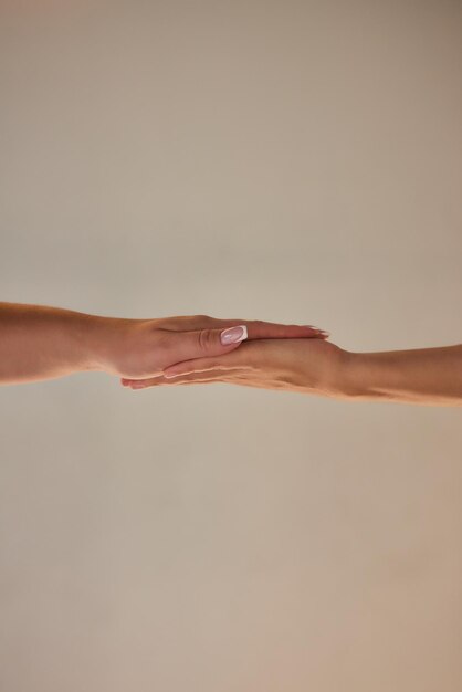 Photo man and woman hands reaching to each other closeup two hands touching isolated on white background