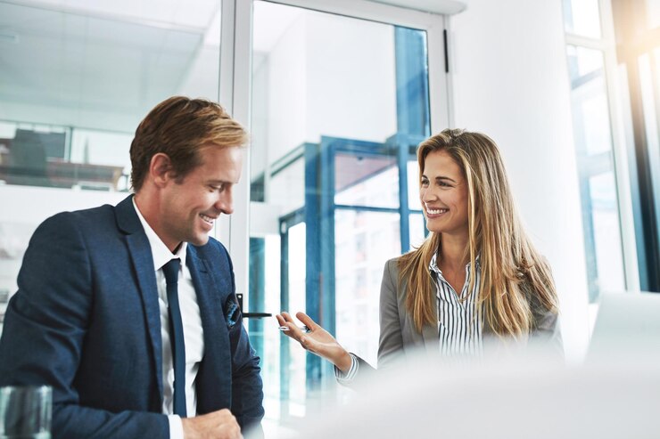 Photo man woman and happy in office for business meeting and advice for company development people technology and discussion in workplace for teamwork positive feedback or pleased for financial growth