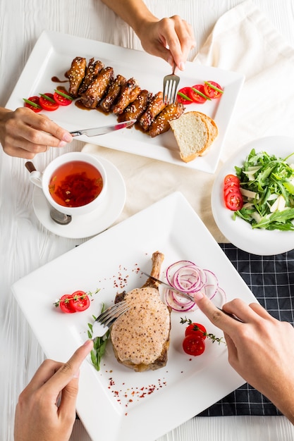 A man and a woman have lunch at a restaurant. The served table.