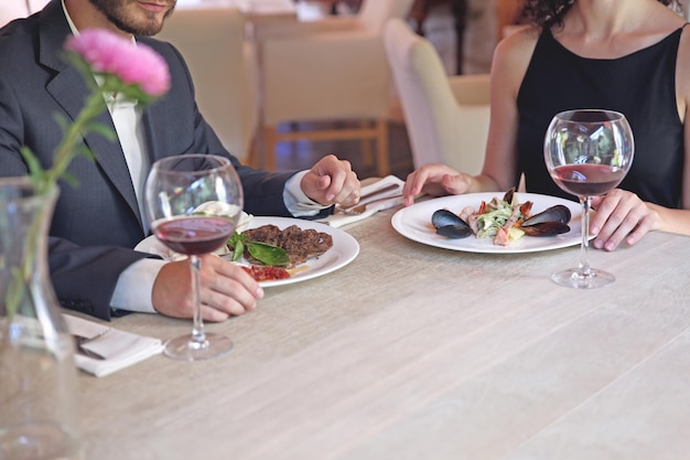 Man and woman having dinner at restaurant closeup