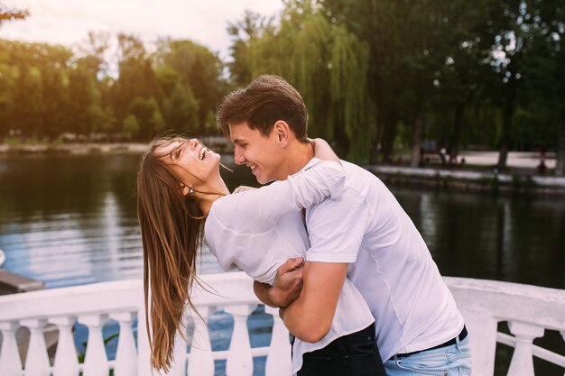 Man and woman having fun on a bridge in the park