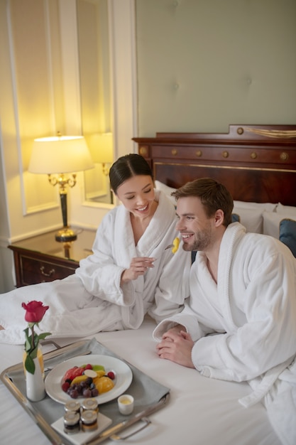 A man and woman having a romantic breakfast together