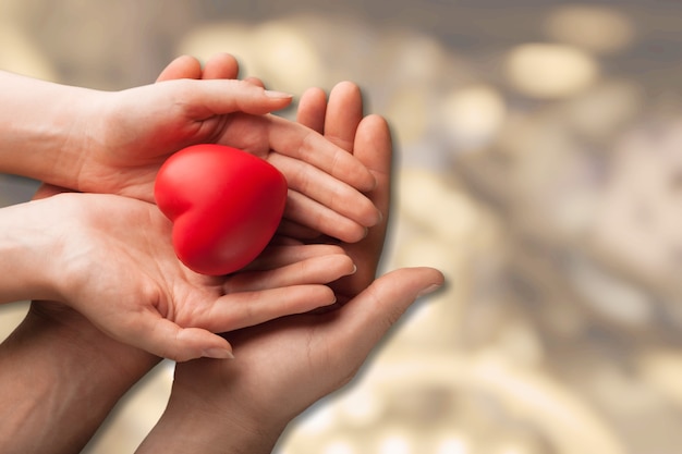 Man and woman holding red heart