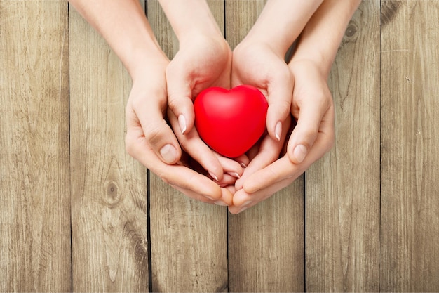 Man and woman holding red heart