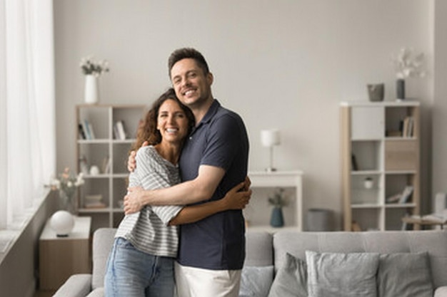 a man and woman hugging in a living room
