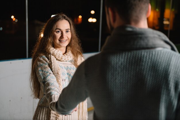 Man and woman on an ice skating rink