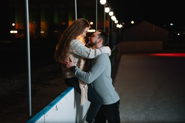 Man and woman on an ice skating rink