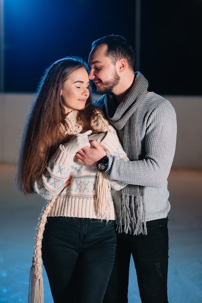 Man and woman on an ice skating rink