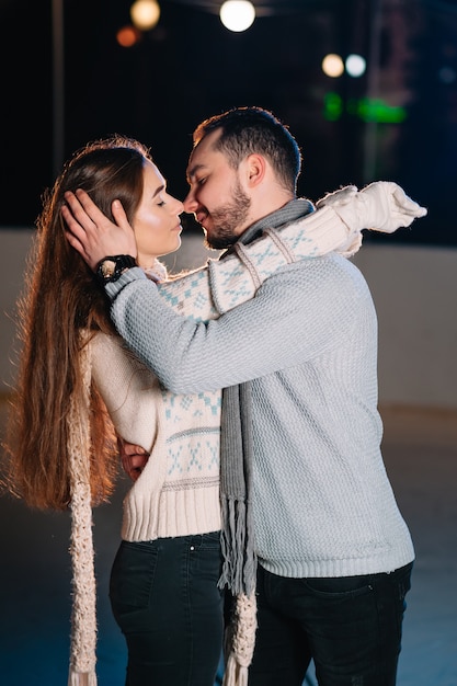 Man and woman on an ice skating rink