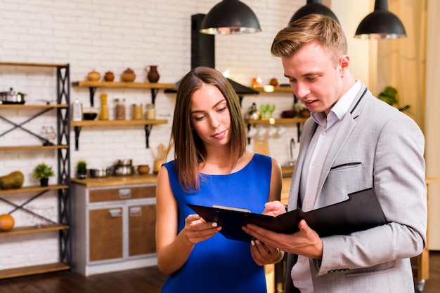 Photo man and woman inspecting a document