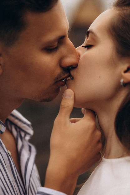 A man and a woman kiss on the street.