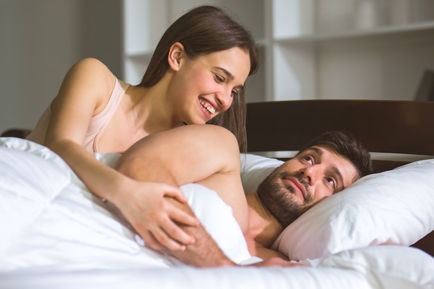 The man and woman lay on the bed