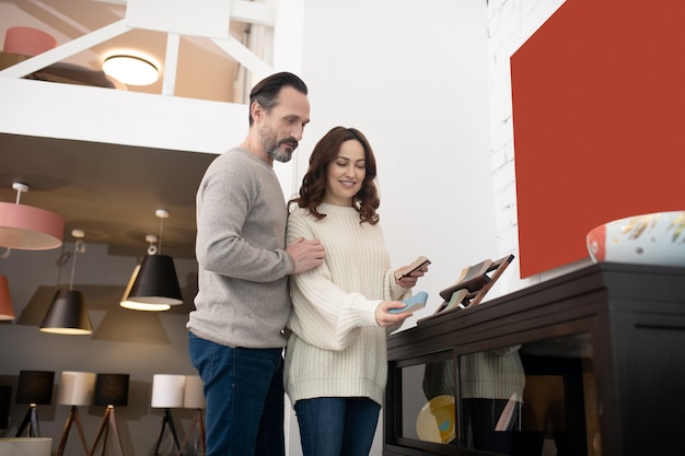 Man and woman looking at the samples in furniture salon