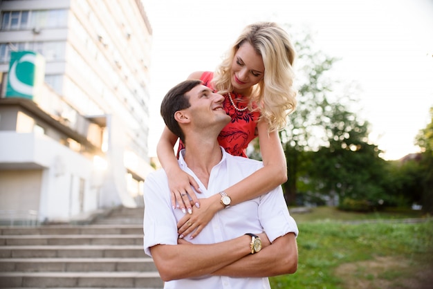 man and woman in love walk in the park and hug.