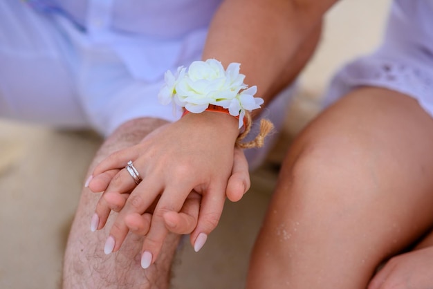 Man and woman newlyweds hold hands closeup
