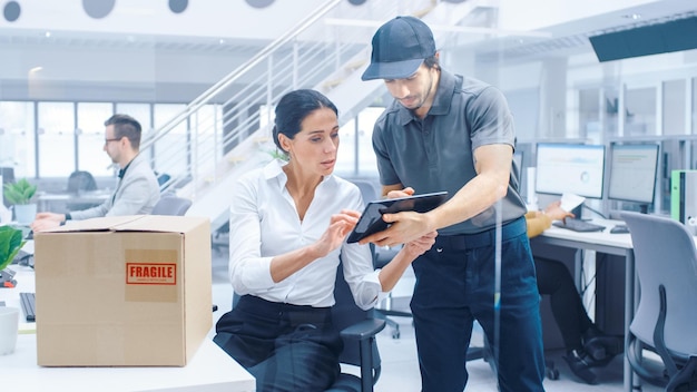 A man and woman in a office with a box that says'safe'on it