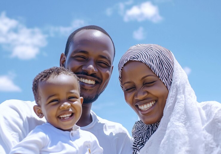 a man and a woman pose for a picture with a child