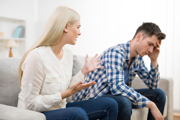 The man and woman quarreling on the sofa