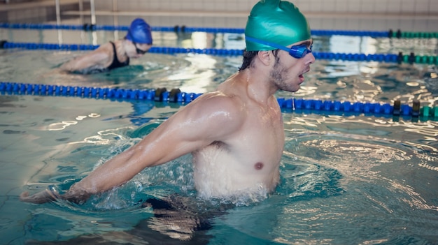 Man and woman racing in the swimming pool