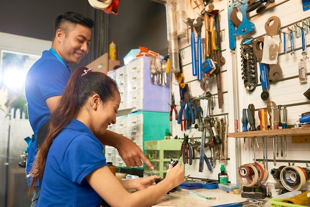 Man and Woman Repairing Bicycle