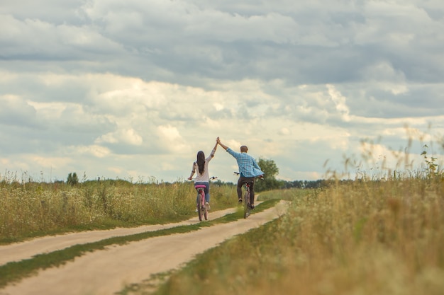 The man and woman riding a bike outdoor