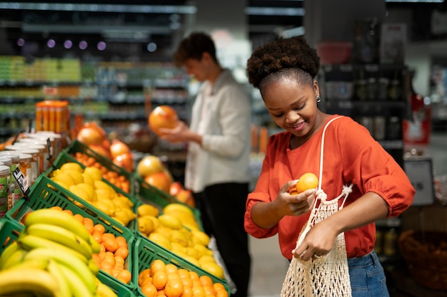 Foto uomo e donna che acquistano al negozio di alimentari