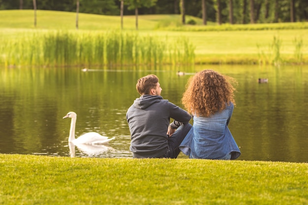 L'uomo e la donna siedono sulla riva del fiume