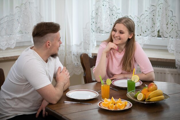 A man and a woman sit at a table and look into each others eyes