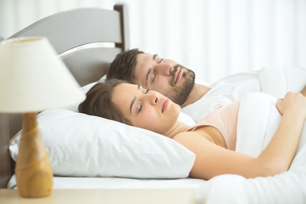 The man and woman sleeping in the bed. full grip focus