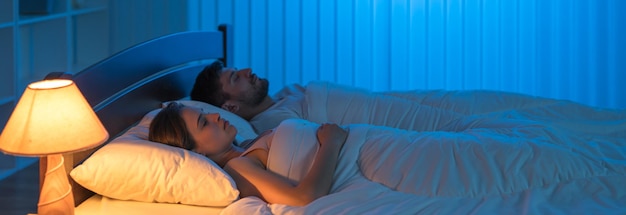 The man and woman sleeping in the bedroom night time