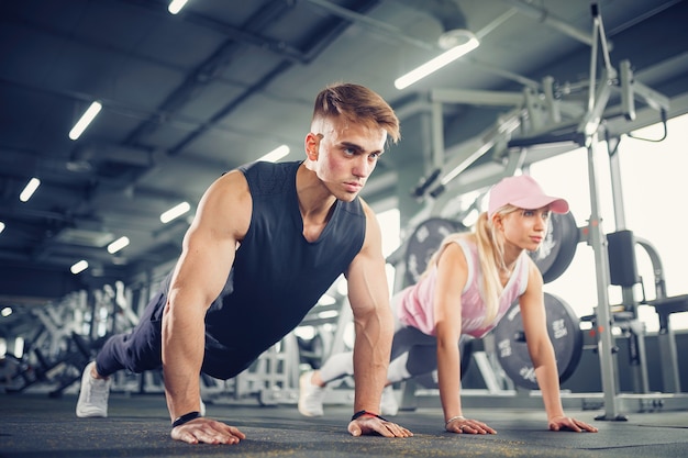 Man and woman strengthen hands at fitness training