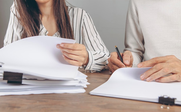 Man and woman study papers