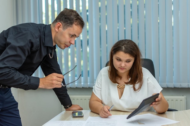 Man and woman studying financial records