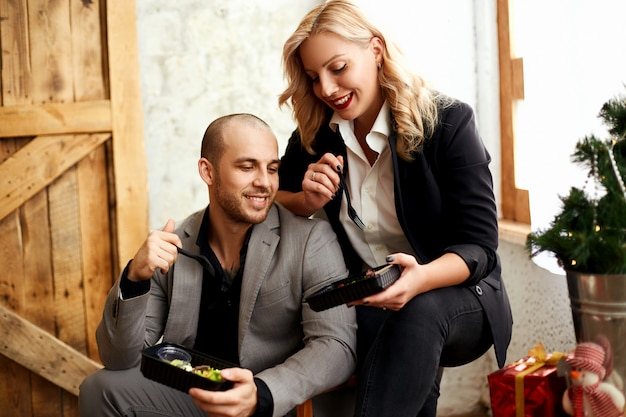 A man and a woman in suits are having lunch. Food delivery