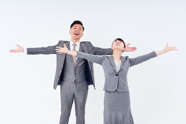 Man and woman in suits posing positively