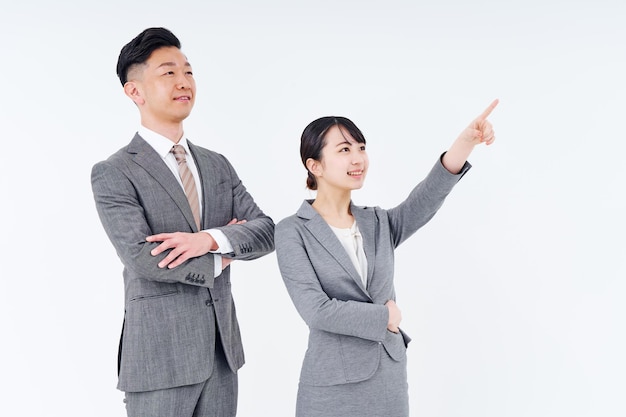 Man and woman in suits posing positively