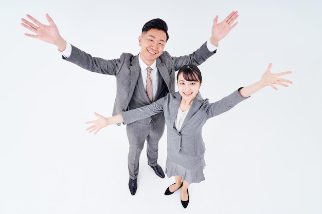 Man and woman in suits posing positively