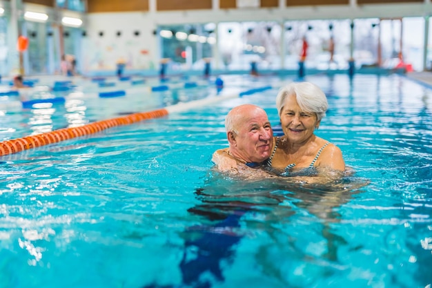 A man and woman in a swimming pool with a sign that says'the word'on it '