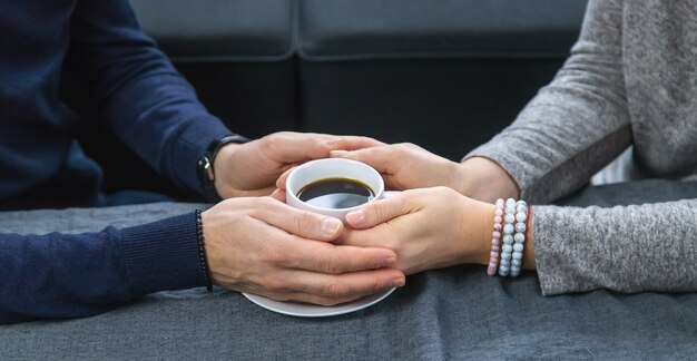 Man and woman at the table with a cup of coffee