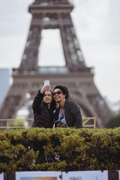 a man and woman taking a picture with a phone