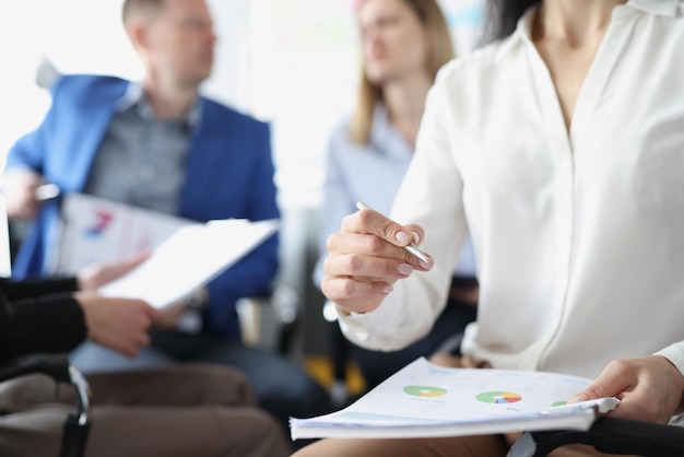 Man and woman talk behind boss