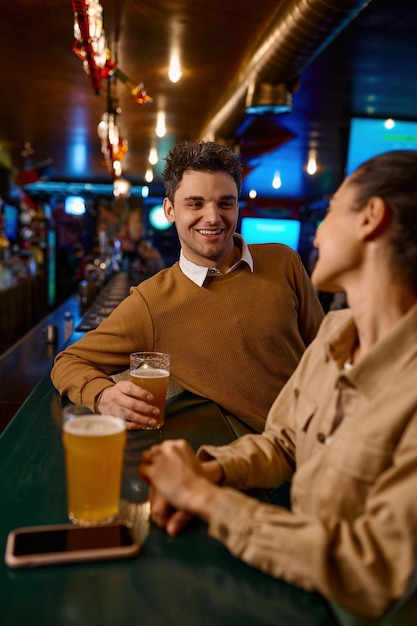 Man and woman talking while enjoying drinks together