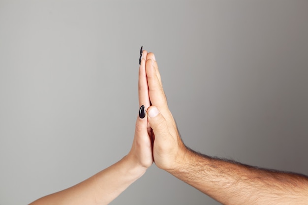 Man and woman touch with palms